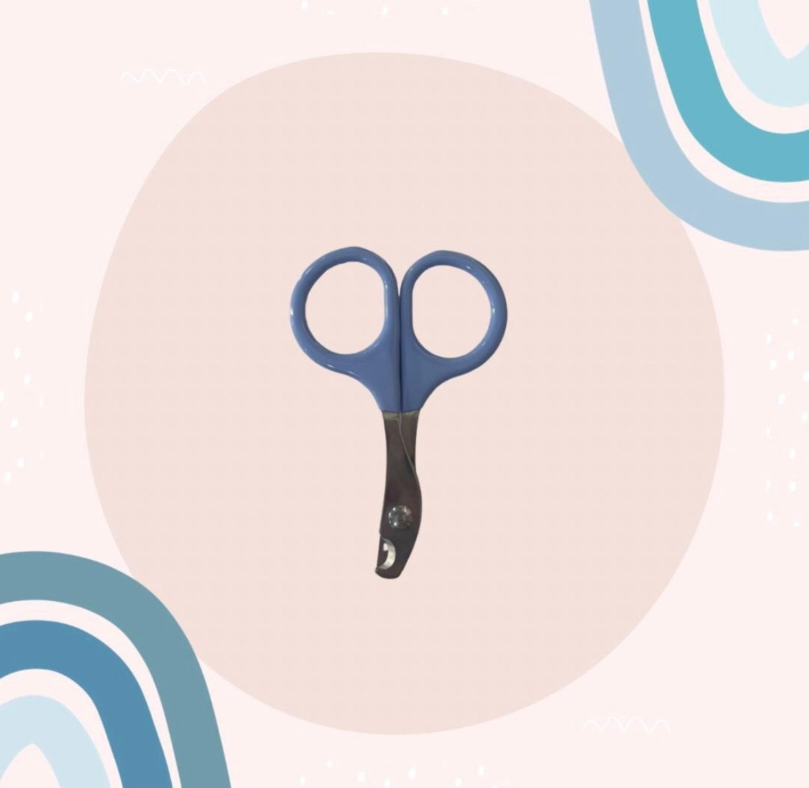 A pair of nail scissors with blue handles and a black grip, centered on a light pink circular background with abstract blue curved shapes.