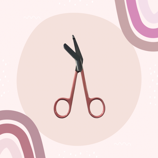 pink lister bandage scissors with curved handle and blunt safety tip. 